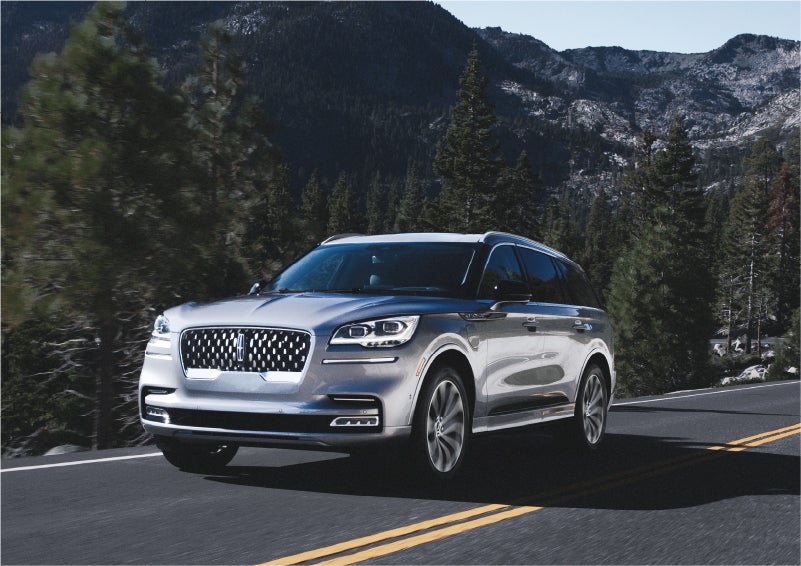 A 2023 Lincoln Aviator® Grand Touring SUV being driven on a winding road to demonstrate the capabilities of all-wheel drive | Lincoln North Miami in North Miami FL