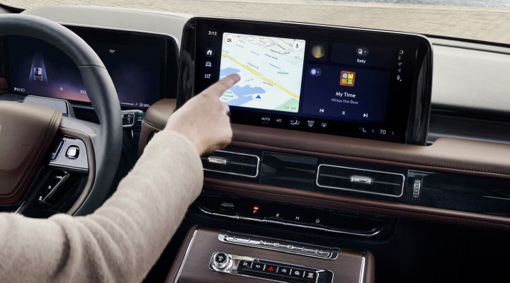 A person is tapping the center display touchscreen of a 2026 Lincoln Aviator® SUV. | Lincoln North Miami in North Miami FL