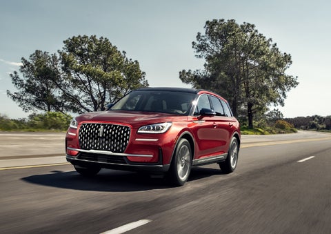 A 2026 Lincoln Corsair® SUV is shown being driven on a country road. | Lincoln North Miami in North Miami FL