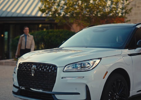 A person approaches a 2026 Lincoln Corsair® SUV as the Lincoln Embrace light sequence takes place. | Lincoln North Miami in North Miami FL
