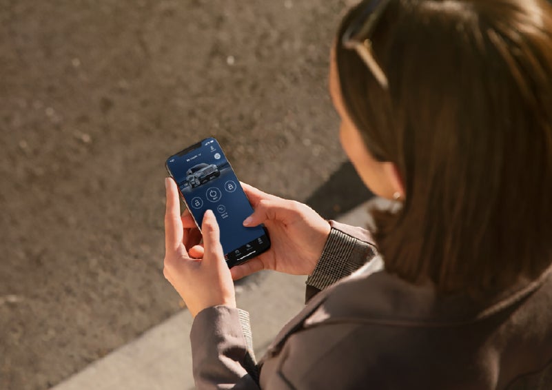 A person is shown interacting with a smartphone to connect to a Lincoln vehicle via the Lincoln Way® app. | Lincoln North Miami in North Miami FL