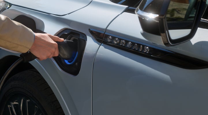 A hand is plugging in a 2026 Lincoln Corsair® Grand Touring Plug-in Hybrid SUV. | Lincoln North Miami in North Miami FL