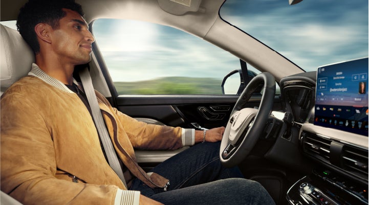 A person is shown using Lincoln BlueCruise hands-free highway driving technology on a divided highway in a hands-free Blue Zone. | Lincoln North Miami in North Miami FL