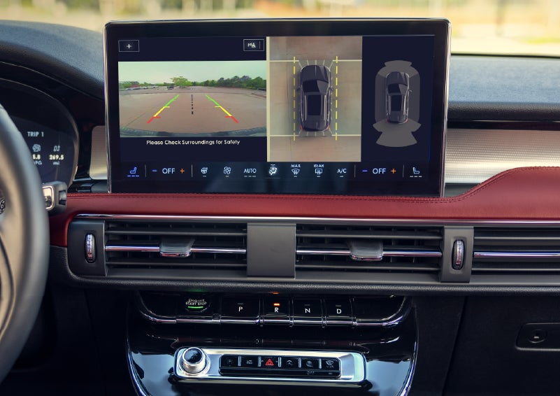 A couple approaches a 2026 Lincoln Corsair® Reserve model as the Lincoln Embrace illumination guides the way | Lincoln North Miami in North Miami FL