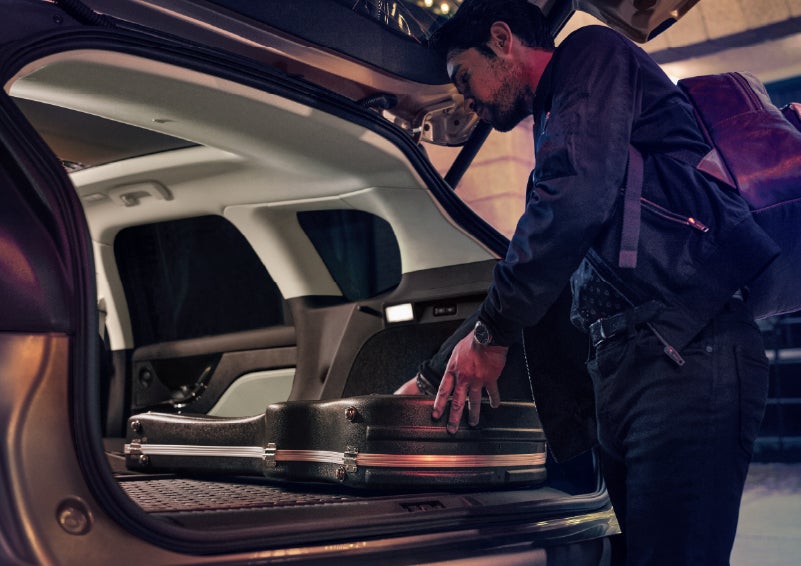 A man is shown loading cargo into the rear of a 2026 Lincoln Corsair® SUV with the second-row seats folded flat. | Lincoln North Miami in North Miami FL