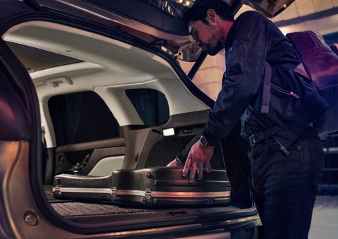 A man is shown loading cargo into the rear of a 2026 Lincoln Corsair® SUV with the second-row seats folded flat. | Lincoln North Miami in North Miami FL