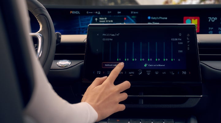 A woman is shown using the Auto Air Refresh feature in the 2026 Lincoln Nautilus® SUV. | Lincoln North Miami in North Miami FL