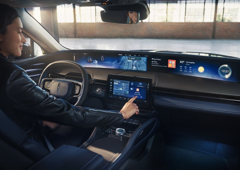 The driver of a 2026 Lincoln Nautilus® SUV interacts with the center touchscreen. | Lincoln North Miami in North Miami FL