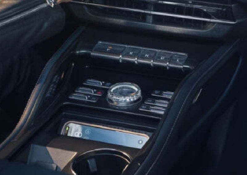A smartphone is shown charging in the wireless charging pad. | Lincoln North Miami in North Miami FL