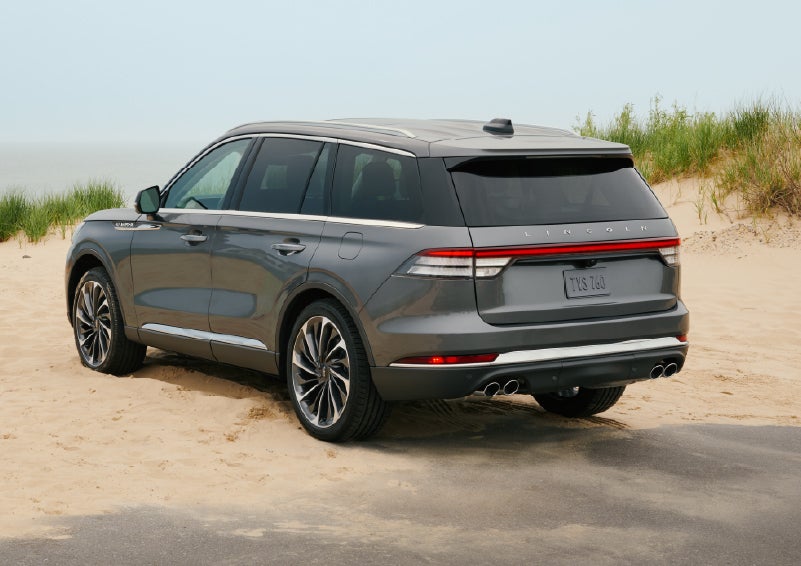 A 2027 Lincoln Aviator® SUV is parked next to sand dunes. | Lincoln North Miami in North Miami FL