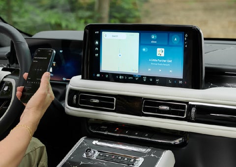 A person pairs thier phone with the center touchscreen of a 2027 Lincoln Aviator® Black Label™ SUV | Lincoln North Miami in North Miami FL
