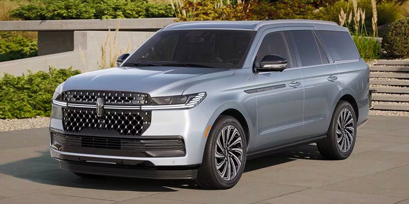 Light blue Lincoln Navigator SUV parked outdoors, showing front and side profile.